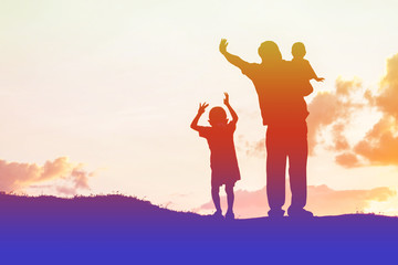 father encouraged her son outdoors at sunset, silhouette concept