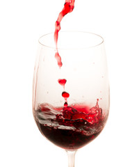 pouring red wine from bottle in the glass