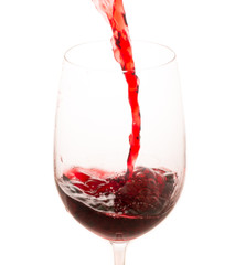 pouring red wine from bottle in the glass