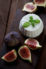 Ricotta cheese with ripe figs, rustic wooden background, closeup