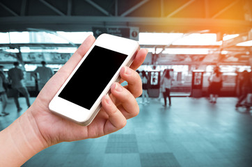 woman hand holding the phone tablet on blur event background