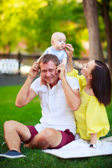 Fototapeta premium Portrait of a father, mother and baby