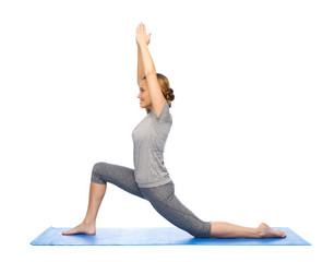 happy woman making yoga in low lunge on mat