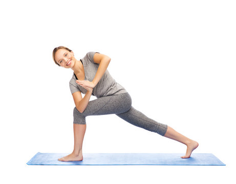 Woman Making Yoga Low Angle Lunge Pose On Mat