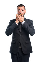 Businessman covering his mouth