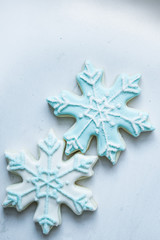 Snowflake cookies on white pastel background