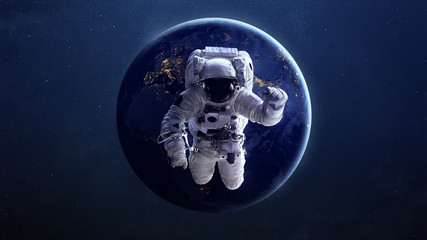 Plakat Astronaut in outer space against the backdrop of the planet earth. Elements of this image furnished by NASA