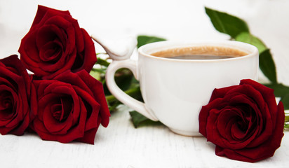 Cup of coffee and red roses