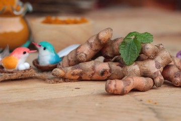 Turmeric herb yellow powder and fresh turmeric.