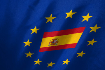 spain flag in EU flag on fabric background