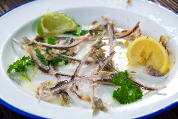 Dirty plate with sardine bones after  meal