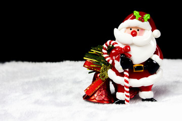 Santa Claus and Christmas bell on black background