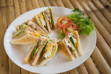 club sandwich in white dish