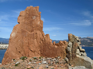 Fototapeta premium Arbatax with the known red porphyry rocks nearby the port at the Capo Bellavista, Sardinia, Italy, Europe