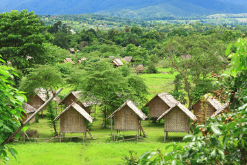 Fototapeta na wymiar Lovely view of the green palm trees bungalows - Himalayan Resort Thailand Pai