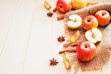 
background, fresh apples with cinnamon and spices on a light wooden background