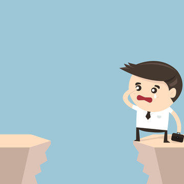 Businessman looking into the cliff gap