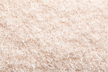 Knitted woolen fabric background, close up