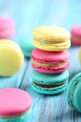 Tasty colorful macarons on a blue wooden table