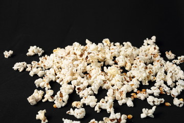 Popcorn in a pile on black background

