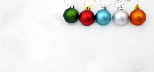 Christmas balls on white snow.