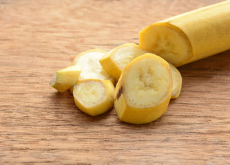 sliced banana in a cup over a table.