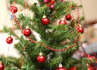 Christmas decorations with red glass balls decorate a large Chri