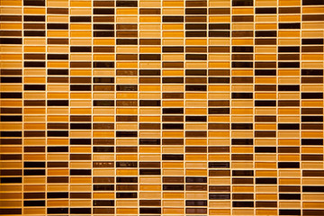 Surface of Mosaic in ancient style stacked with tiny brown, yell