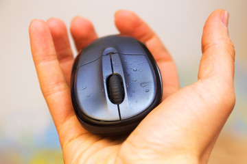 Open Hand and computer mouse  with water drops