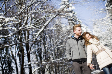 Loving young couple at winter forest