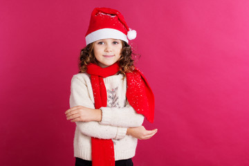 Child girl is wearing santa hat 