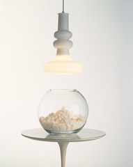 Sugar Cubes in Fishbowl on Table Under Tungsten Light