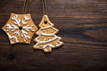 Gingerbread cookies over wooden background..