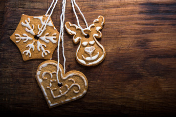 Gingerbread cookies over wooden background..