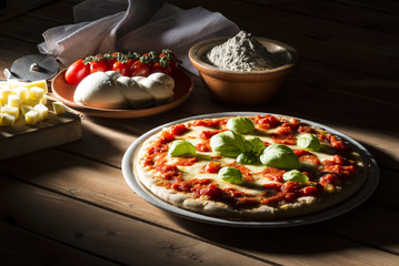 Pizza with tomatoes mozzarella and basil on the wooden table