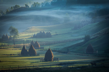 Church at sunrise in foggy morning - Alba, Romania