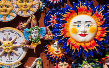 Traditional souvenirs of ceramics and Trinacria is symbol of Sicily, Italy.
