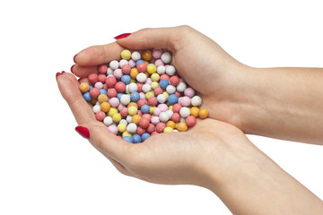 Colored candies in female hands