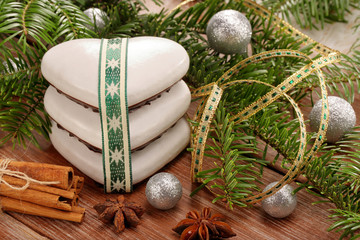 Christmas gingerbread with white icing and decoration on wooden