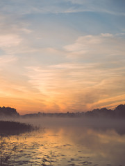 Foggy morning on the country lake - vintage effect