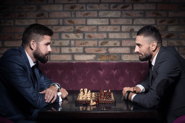 two successful young men playing chess © goami