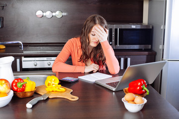 stressed young woman is doing banking and administrative work ho