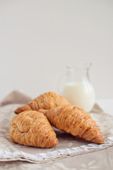 Romantic breakfast with croissant, coffee, milk, honey and jam on the table