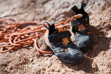 Poster Rock climbing shoes over belay rope closeup © serhiipanin