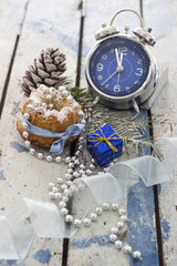 Christmas decoration and gifts. Christmas tree, pine cone, clock and gift on wooden