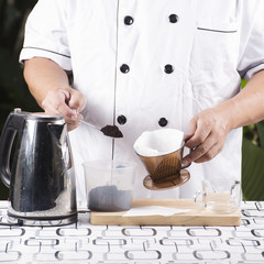 Chef putting grind cofffe