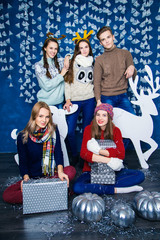 Company of boy and four girls in blue and white Christmas decora