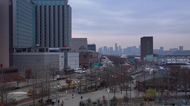 An evening skyline establishing shot of the area around Pier 84 in midtown Manhattan.  	