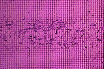 Scratched pink plastic mat surface