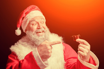 Santa Claus laughing and angry because of the very small gift